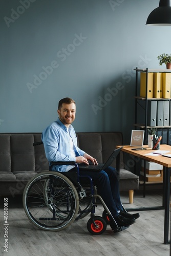 Man in wheelchair at home or in office.