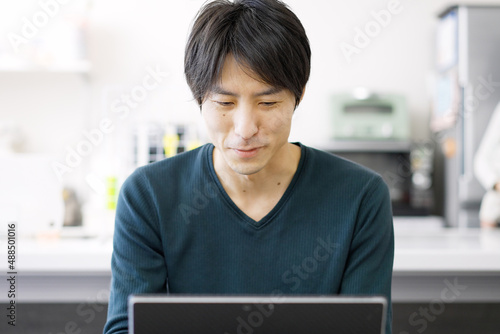 パソコンを使って家で仕事をするアジア人男性 Free Download パソコンを使って家で仕事をするアジア人男性 - GFXLoad