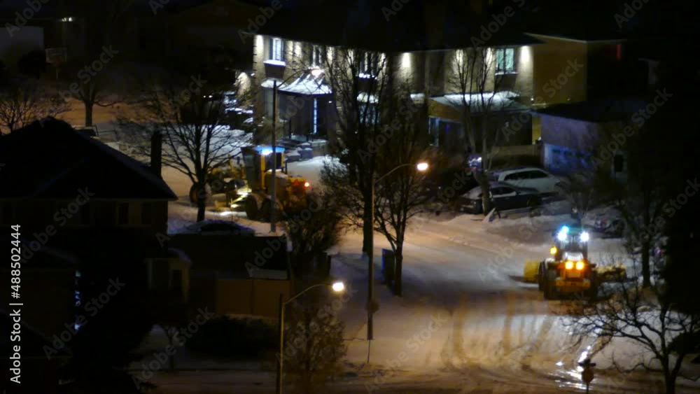 Workers and bulldozers at work by night clearing snow from the road. Mississauga. Canada. Static view. Real Time. Workers and bulldozers at work by night clearing snow from the road. Mississauga. Canada. Static view. Real Time.