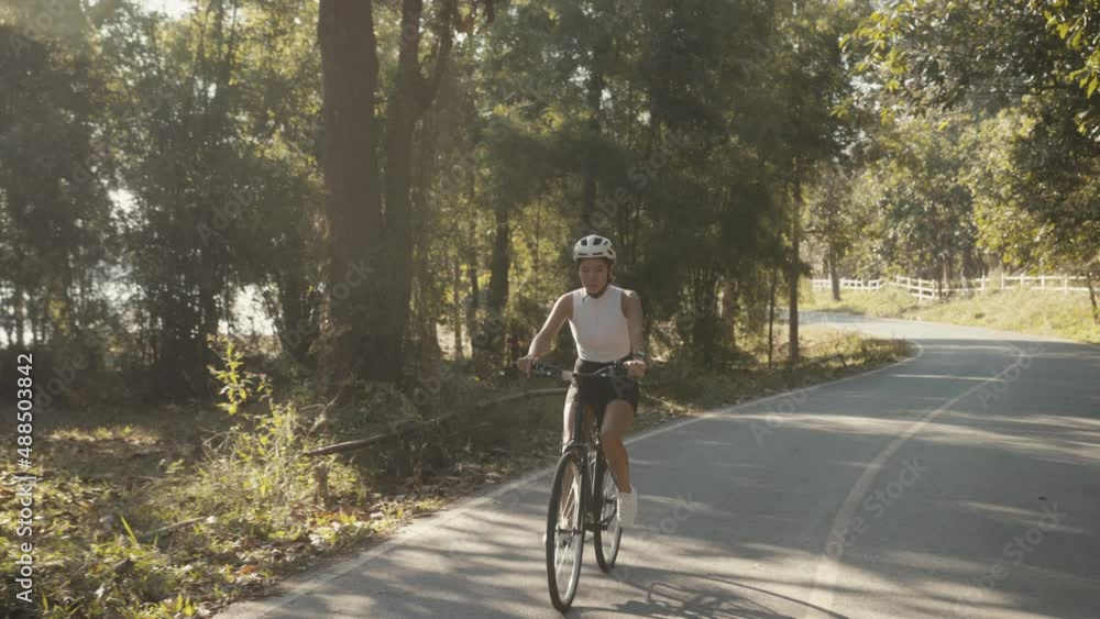 cyclist girl training. Cyclist Woman in Helmet on Bike cyclist girl training. Cyclist Woman in Helmet on Bike
