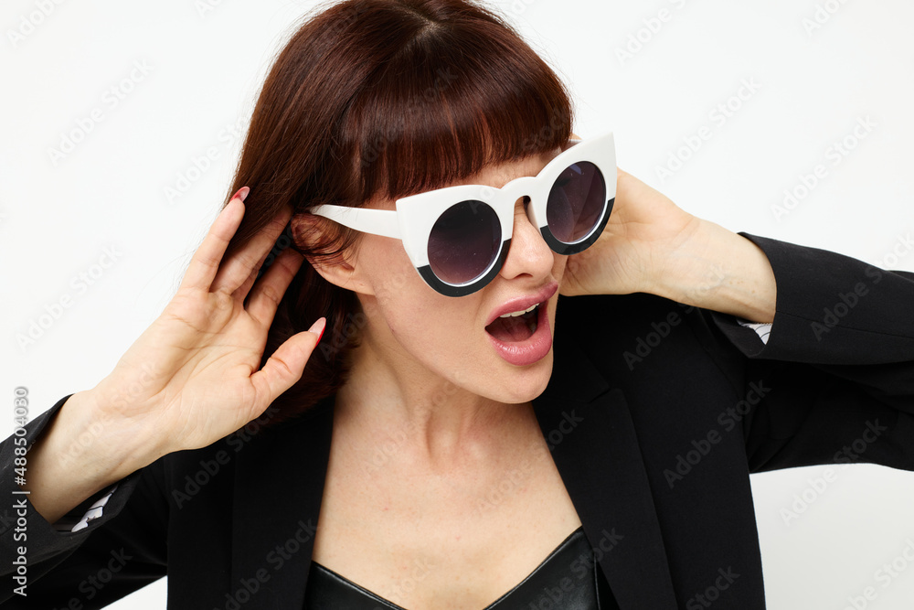 beautiful woman in a black jacket red nail polish stylish sunglasses isolated background beautiful woman in a black jacket red nail polish stylish sunglasses isolated background