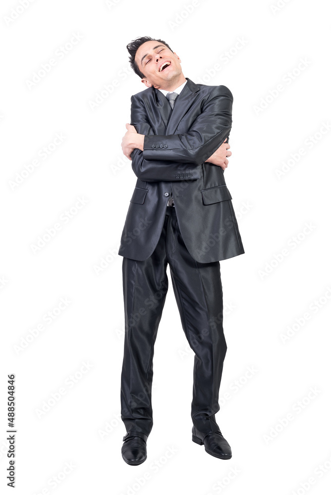 Smiling man in suit embracing himself. White background. Smiling man in suit embracing himself. White background.
