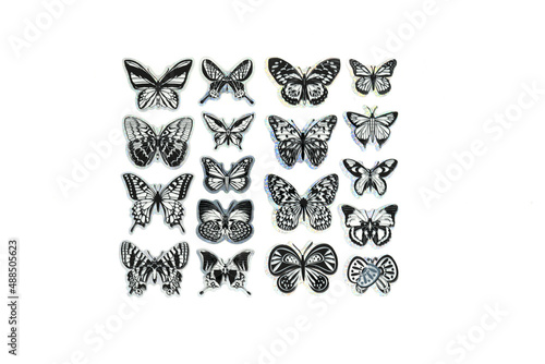 Close-up of plastic black and white toy butterfly isolated on white.