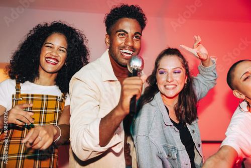 Group of friends singing during karaoke night