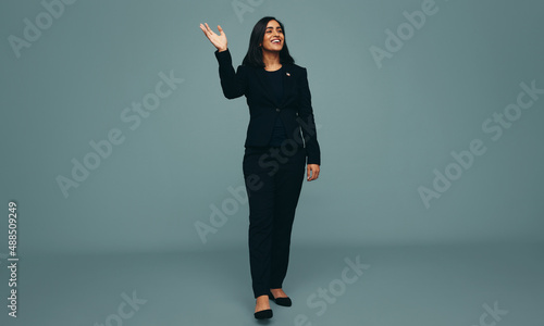Patriotic young politician waving her hand in a studio photo