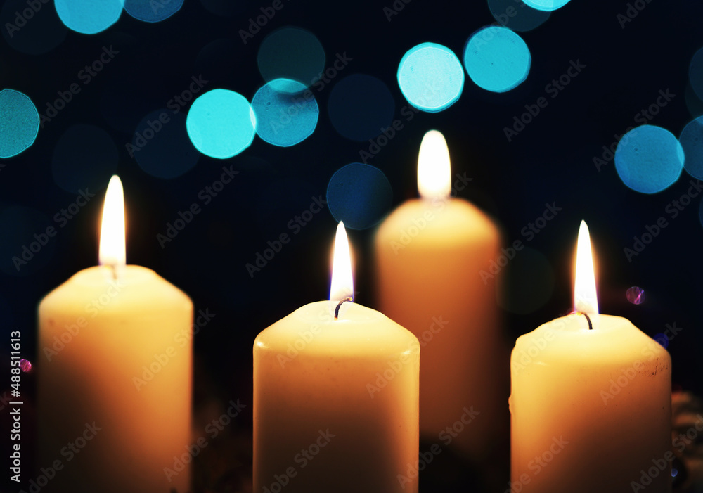 Four burning candles on black background Four burning candles on black background