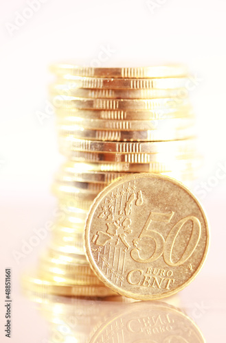 Coin pile with fifty cent euro isolated on white background photo