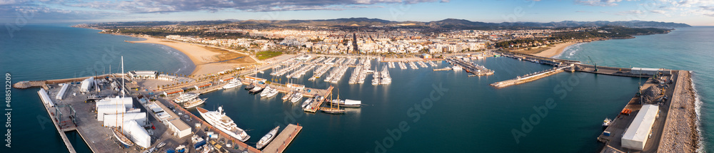 View from drone of Vilanova i la Geltru beach and fishing port with boats at Catalonia, Spain