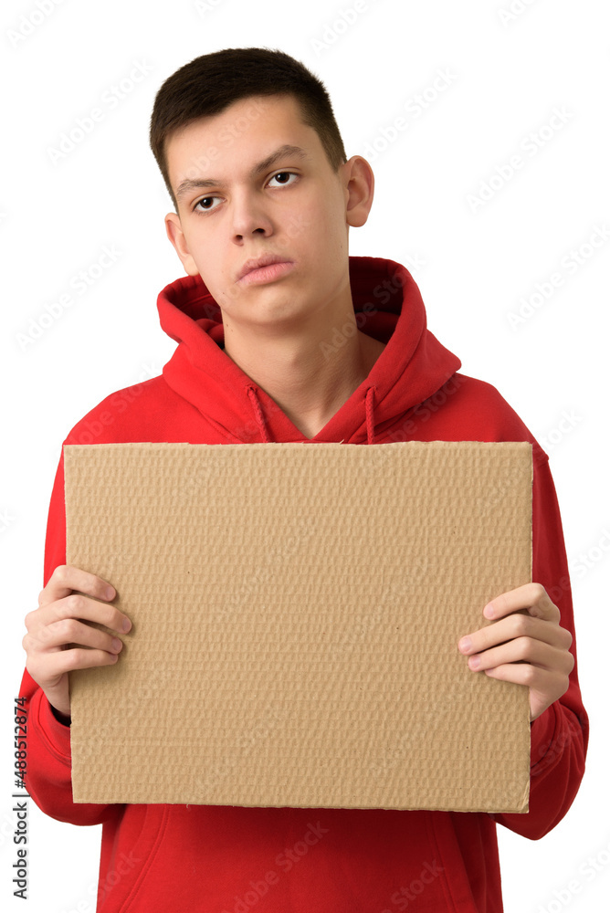 Bored exhausted teenage boy holding blank brown cardboard banner, tired of problems. Young guy with expression of indifference feeling upset. He is fed up. Half-length portrait isolated on white.