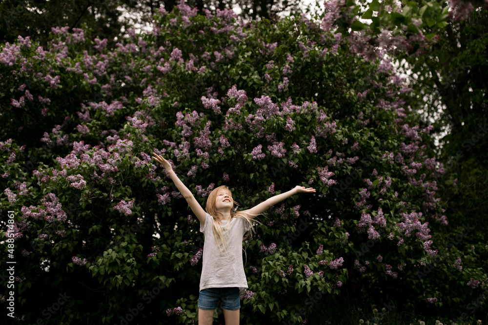 Girl with arms raised in nature Girl with arms raised in nature