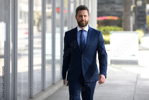 Portrait of businessman standing in a office.