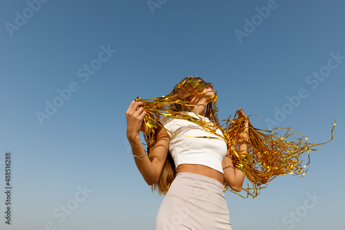 Happy woman with gold tinsel in her hair photo