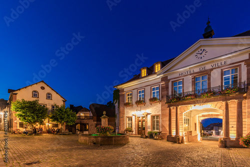 France, Alsace, Ribeauville, Empty town square and illuminated entrance of Hotel de ville at dusk