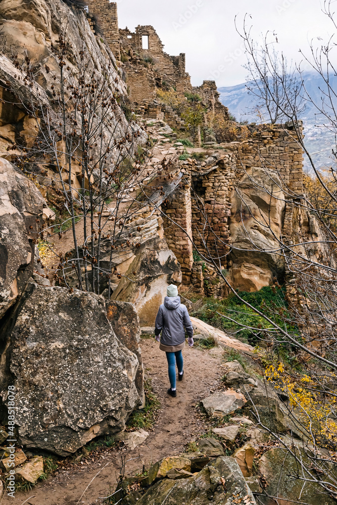Russia, Dagestan, Gamsutl, Female tourist exploring old abandoned mountain village in North Caucasus Russia, Dagestan, Gamsutl, Female tourist exploring old abandoned mountain village in North Caucasus