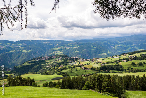 Italy, South Tyrol, Vols am Schlern, Summer clouds over mountain village in Dolomites photo