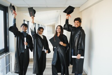 education, graduation and people concept - group of happy international students.