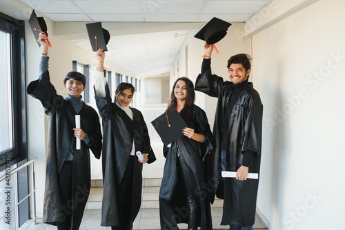 education, graduation and people concept - group of happy international students.