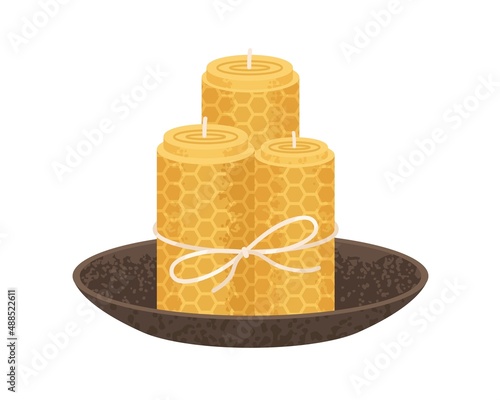 Rolled honeycomb candles in bowl. Natural beeswax pillars with honey scent. Handmade cosy home interior decoration tied with string. Flat vector illustration isolated on white background