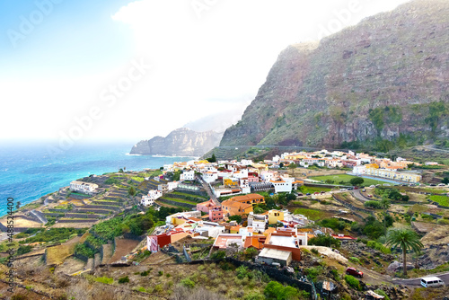 Agulo village, La Gomera, Canary Islands, in winter: colorful houses and terrace fields above the deep blue atlantic ocean. photo