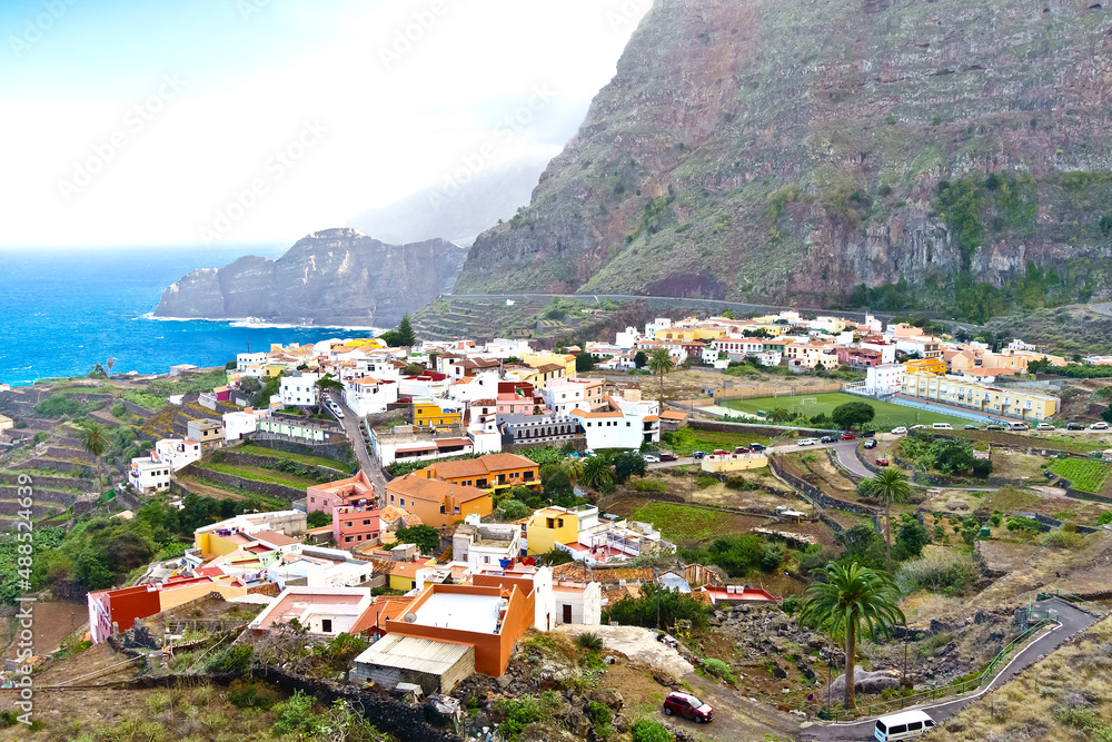 Agulo village, La Gomera, Canary Islands, in winter: colorful houses and terrace fields above the deep blue atlantic ocean.