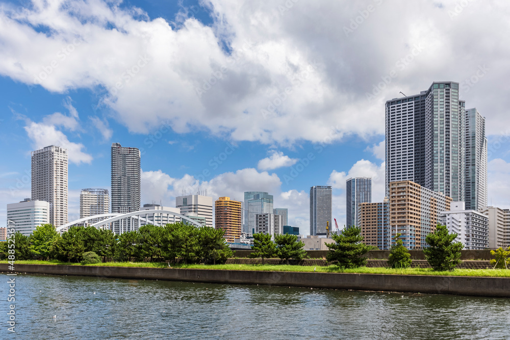 Japan, Kanto Region, Tokyo, Riverside promenade with downtown skyscrapers in background Japan, Kanto Region, Tokyo, Riverside promenade with downtown skyscrapers in background