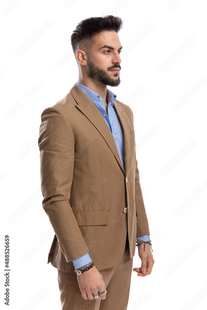 unshaved businessman in brown suit standing in line and looking to side unshaved businessman in brown suit standing in line and looking to side