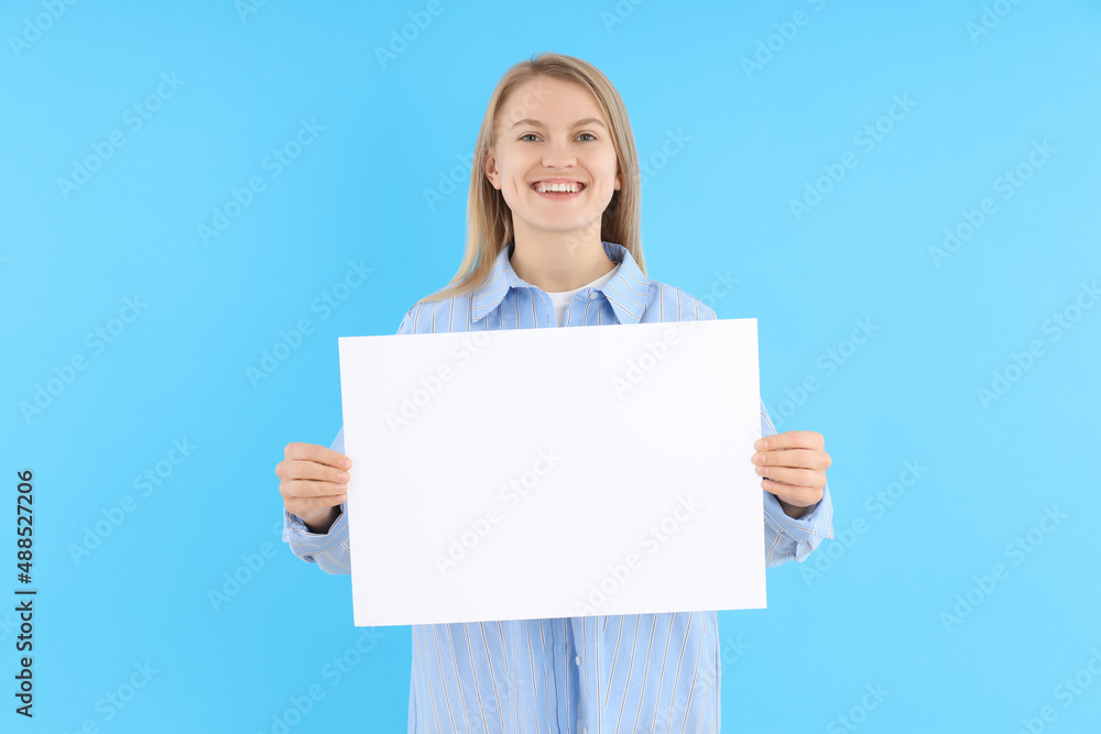Woman holds blank banner on blue background Woman holds blank banner on blue background