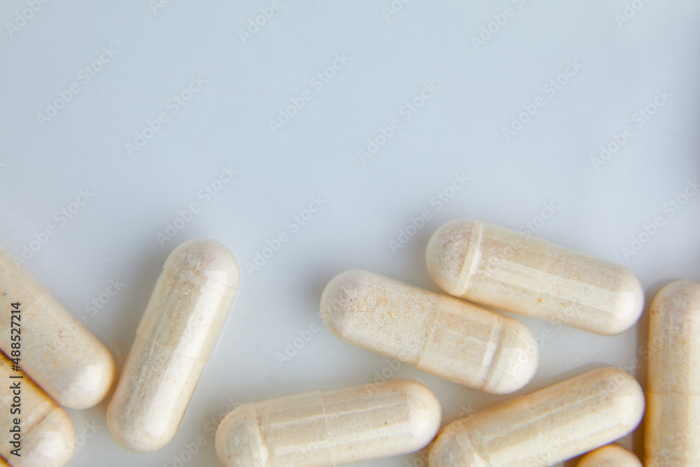 Flat lay macro White beige capsule pills tablets top view close up texture background pharmaceutical industry concept copy space. Stock Photo Adobe Stock