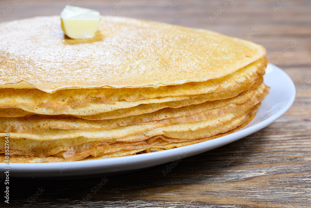 Stack of pancakes with butter on wooden table Close-up Stack of pancakes with butter on wooden table Close-up