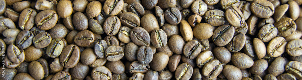 roasted coffee beans close-up. invigorating drink. power engineering specialist. Horizontal image. Banner for insertion into site. roasted coffee beans close-up. invigorating drink. power engineering specialist. Horizontal image. Banner for insertion into site.