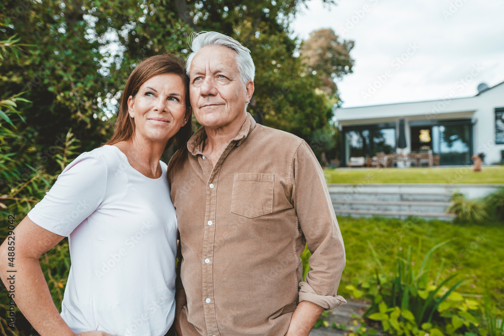 Smiling man and woman standing together at backyard Smiling man and woman standing together at backyard