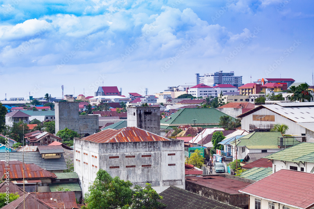 a view of dense houses in the city of Banjarmasin, Indonesia.  view from the roof of the housing. Aerial view of city in Banjarmasin, Indonesia. 