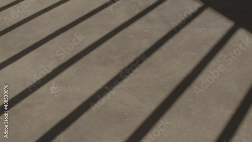Wallpaper Mural Moving shadow of jail bars over concrete Torontodigital.ca