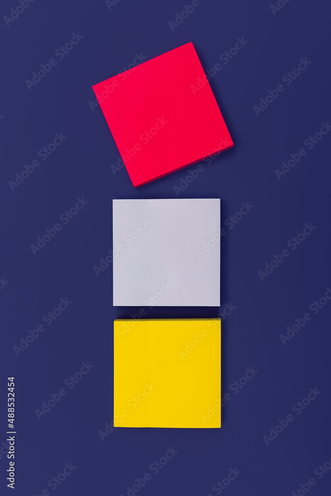 Fototapeta premium Three blank color square sticky note on purple background, top view. Blank space for future important events announcements. Vertical photo