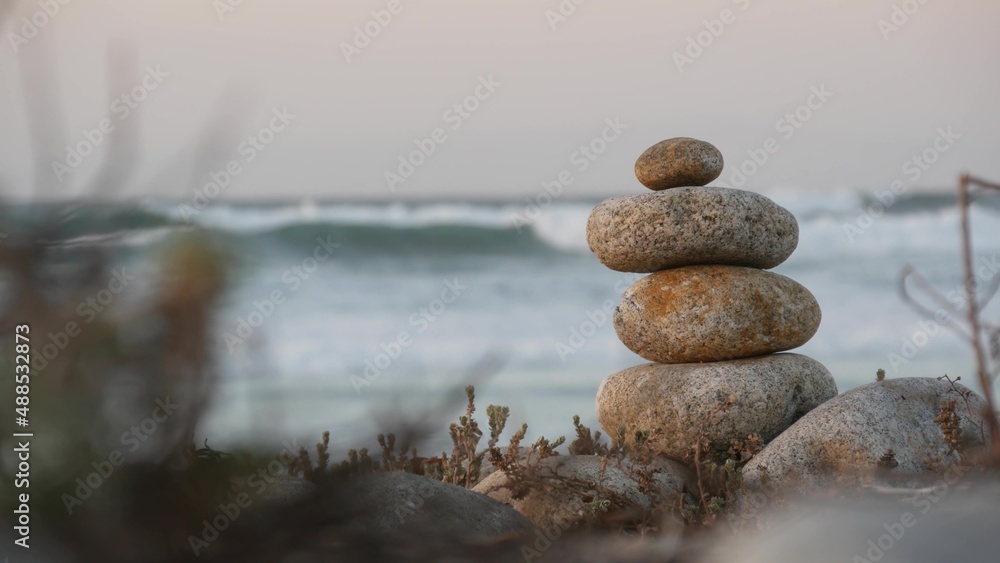 Rock balancing on pebble beach, Monterey 17-mile drive, California coast, USA. Stable pyramid stacks of round stones, sea ocean water waves crashing at sunset. Serenity harmony, calm zen meditation. Rock balancing on pebble beach, Monterey 17-mile drive, California coast, USA. Stable pyramid stacks of round stones, sea ocean water waves crashing at sunset. Serenity harmony, calm zen meditation.
