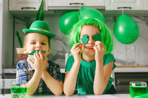 Two toddler boy and girl celebrate the holiday on March 17. Child celebrate St. Patrick's Day. Traditions, holidays concept.
