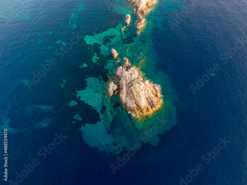 Aerial drone view of small island next to arillas beach in corfu greece