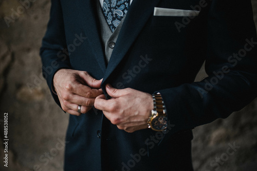 Young handsome man in classic suit. Young businessman puts on suit and prepares for a meeting.