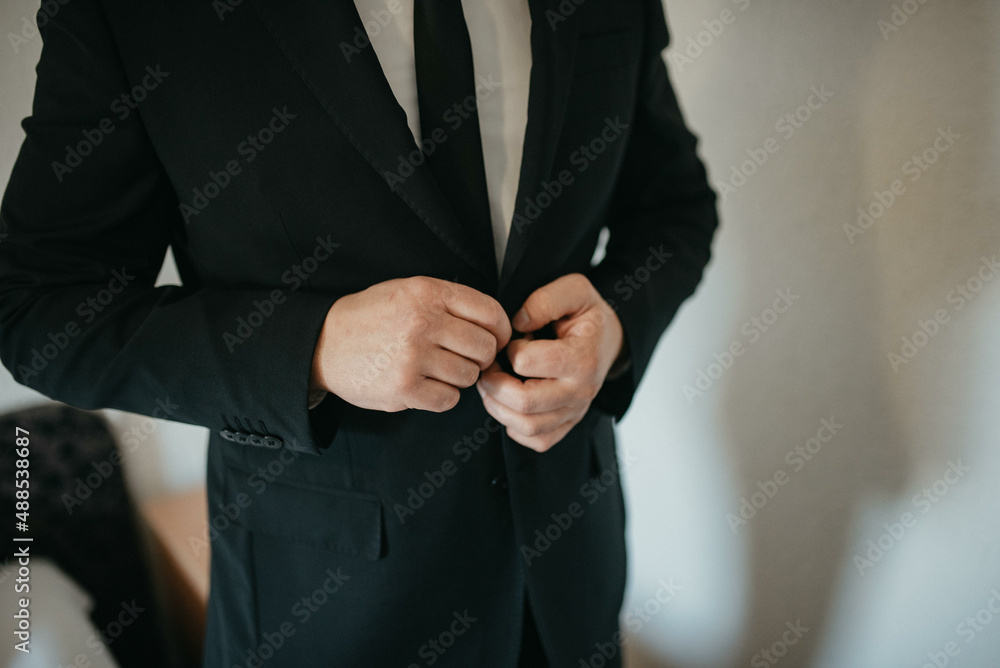 Young handsome man in classic suit. Young businessman puts on suit and prepares for a meeting. Young handsome man in classic suit. Young businessman puts on suit and prepares for a meeting.