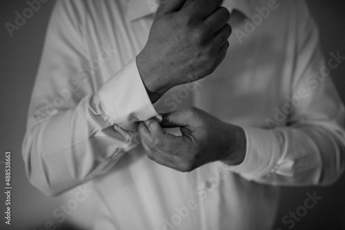 Young handsome man in classic suit. Young businessman puts on suit and prepares for a meeting. © Tobica