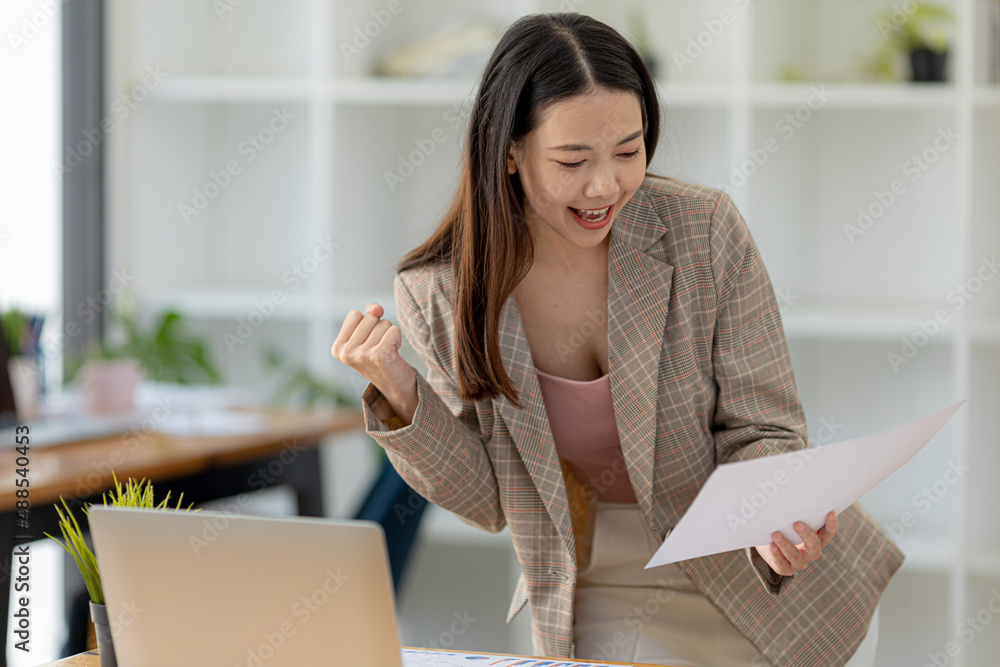 Woman gesturing and looking at the document, businesswoman checking company monthly sales and pretending to be happy as sales meet planned targets according to policy. Sales management concept. Woman gesturing and looking at the document, businesswoman checking company monthly sales and pretending to be happy as sales meet planned targets according to policy. Sales management concept.
