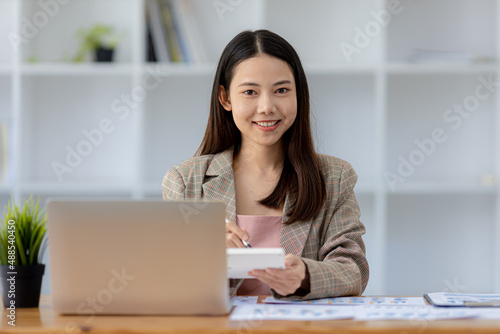 Beautiful Asian woman is a businesswoman who leads a new generation of startups, a woman who runs and manages a business plan to build confidence and stability in business, woman-led business concept.