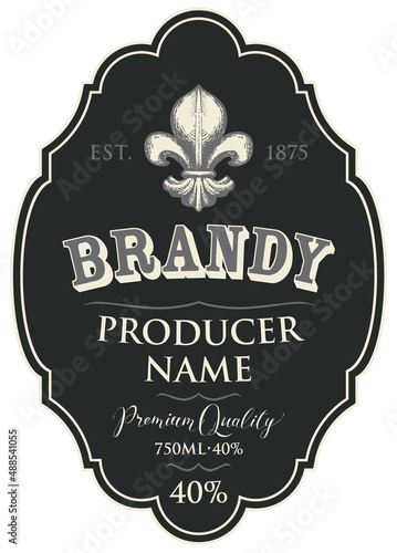 Vector label for Brandy with a hand-drawn fleur de lis on a black background in a curly frame. Figured label or sticker for strong alcohol drinks in retro style, isolated on a white background