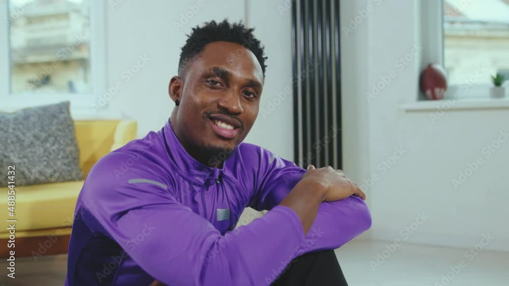 Smiling attractive african american man looking into the camera after training in modern apartment at home decisive healthy portrait slow motion Smiling attractive african american man looking into the camera after training in modern apartment at home decisive healthy portrait slow motion
