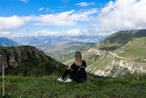 A girl on the background of a view of the Matlas plateau. Khunzakhsky district. Dagestan Russia 2021 photo