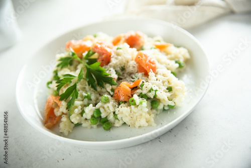 Homemade risotto with salmon and green pea