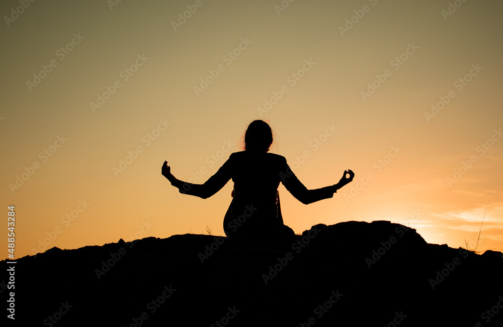 girl doing yoga at sunset