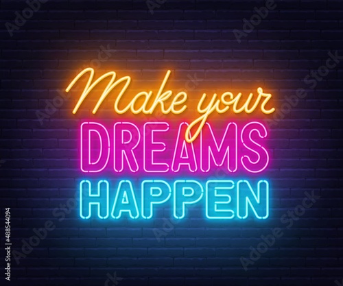 Make Your Dreams Happen neon lettering on brick wall background.