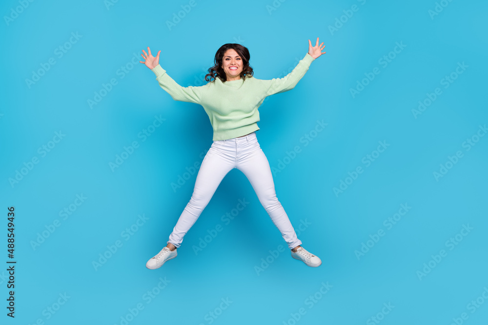 Fototapeta premium Full length photo of impressed young brunette lady wear shirt pants footwear isolated on blue background