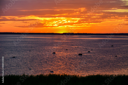 Midnight sun at summer solstice in Oulu, Finland looking at the beach of Bothnian Gulf photo